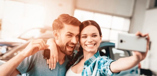 A Man And A Woman Do Selfie Near Their New Car.