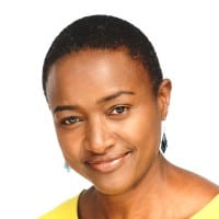 Confident woman with a subtle smile against a white background.