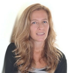A professional portrait of a woman with long blonde hair and a faint smile against a white background.