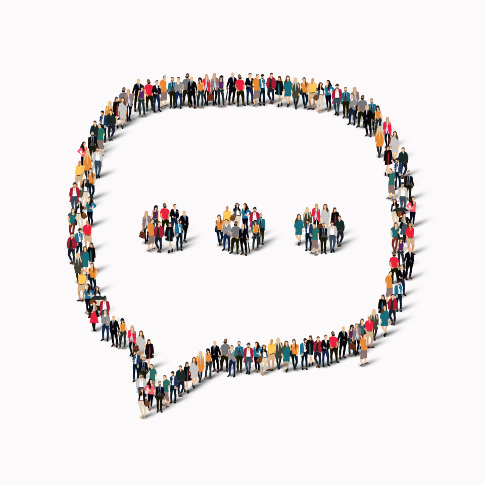 A group of people standing in formation to shape a speech bubble on a white background.