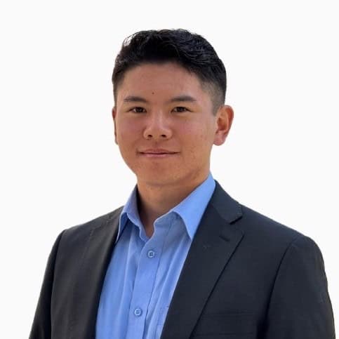 Jeffrey Fang. A young man with short dark hair wearing a blue dress shirt and a dark suit jacket, smiling slightly, posed against a plain white background.
